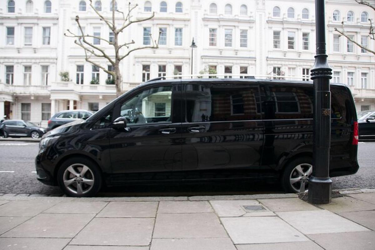 a black van parked next to a street light