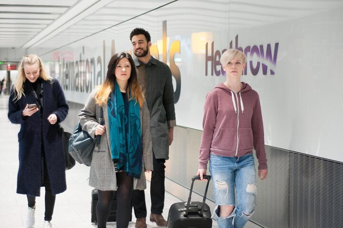 a group of people walking through an airport