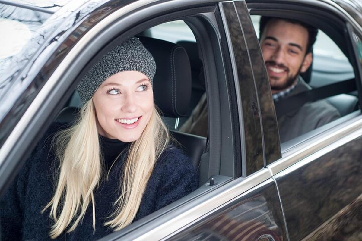 a man and a woman sitting in a car