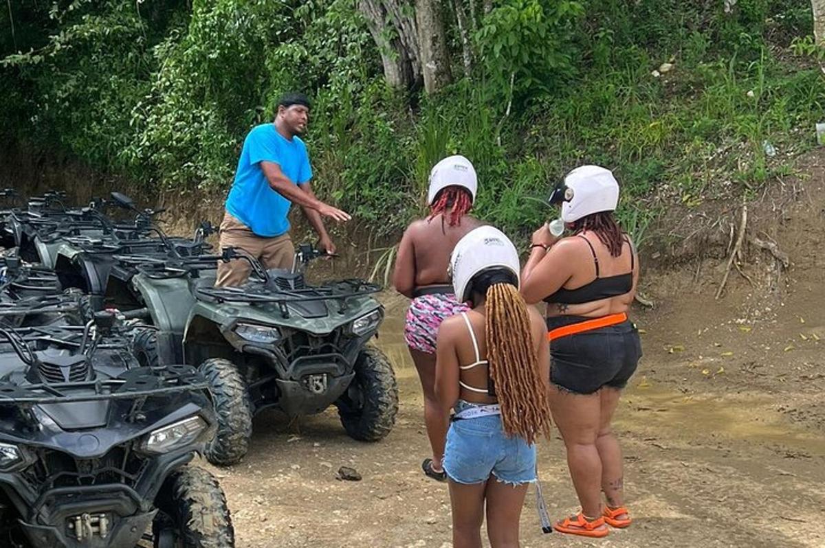 a group of people standing around atvs