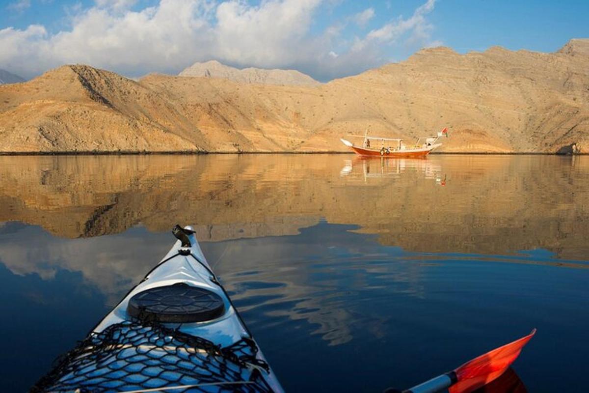 a boat in the water next to a boat on a lake