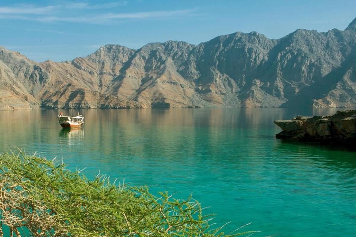 a boat on a lake with mountains in the background