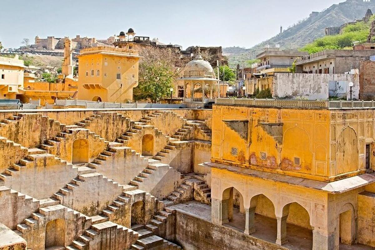 an ancient amphitheater in a city with buildings