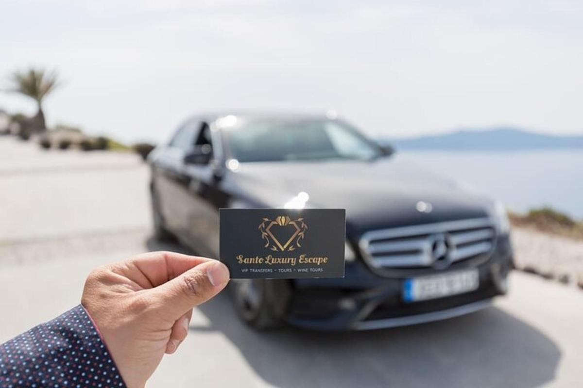 una persona che tiene in mano un biglietto da visita davanti a un'auto