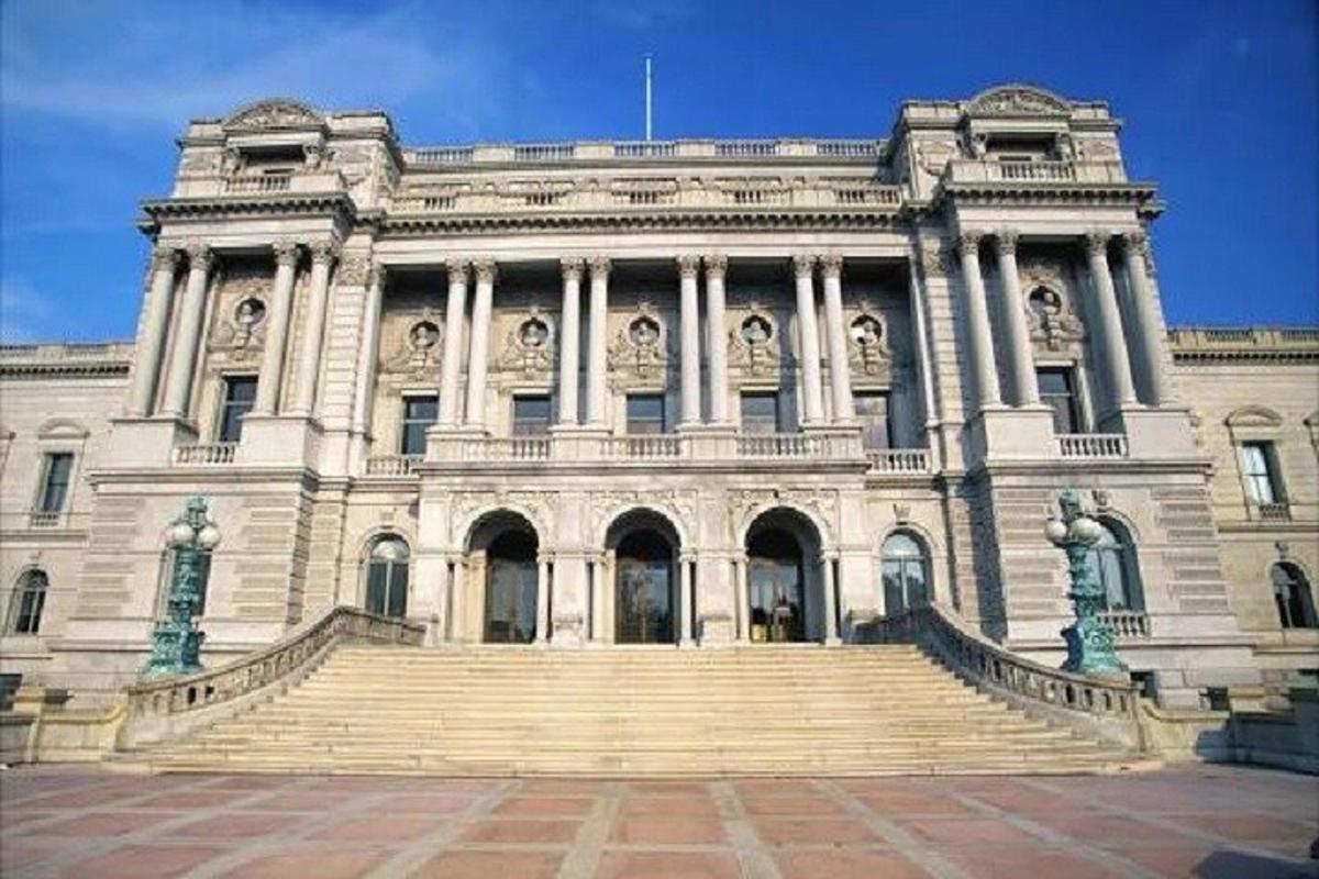 a large white building with stairs in front of it
