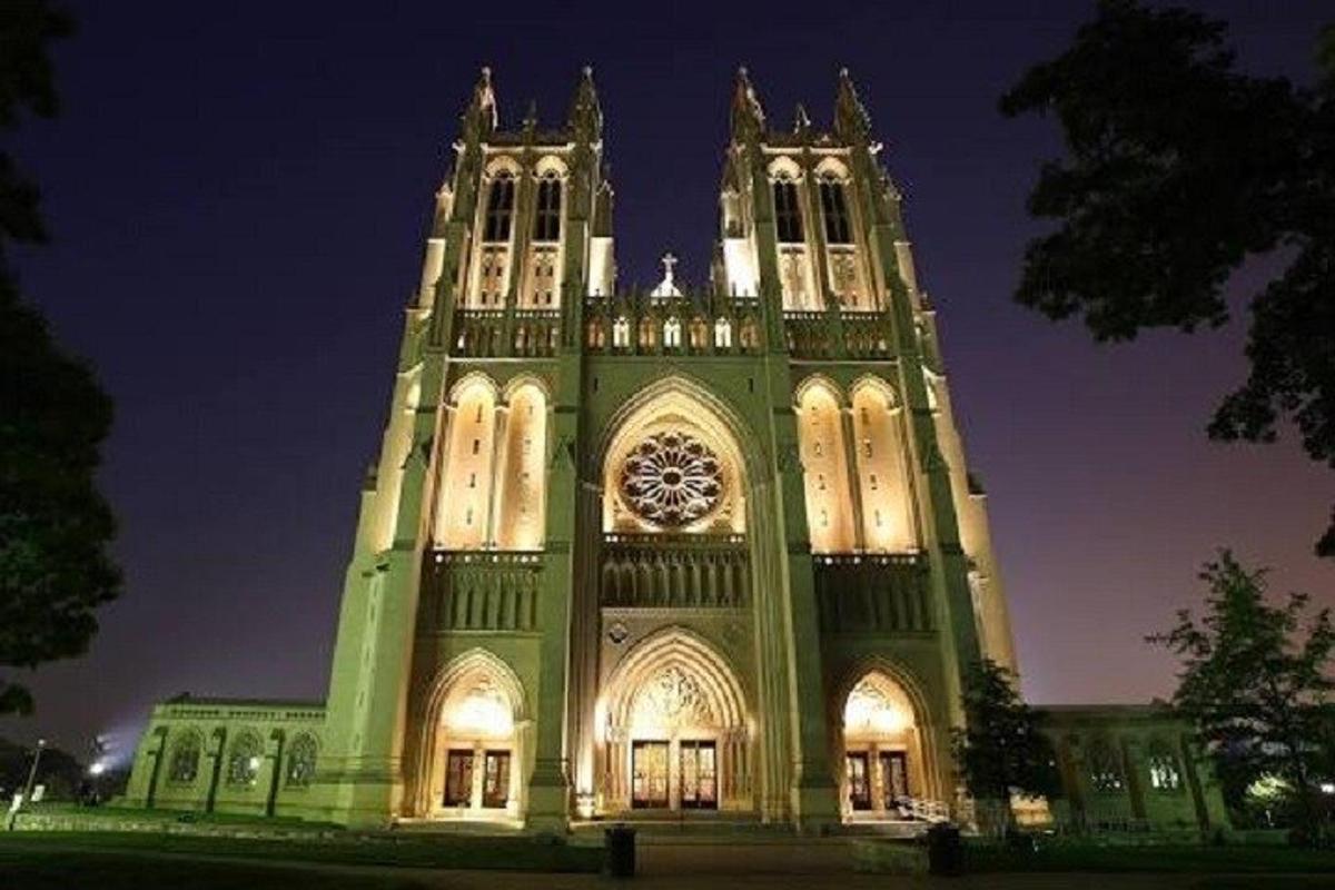 a large building with a clock tower at night