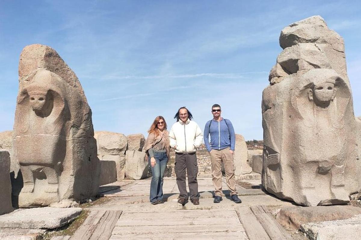 three people standing in front of a statue
