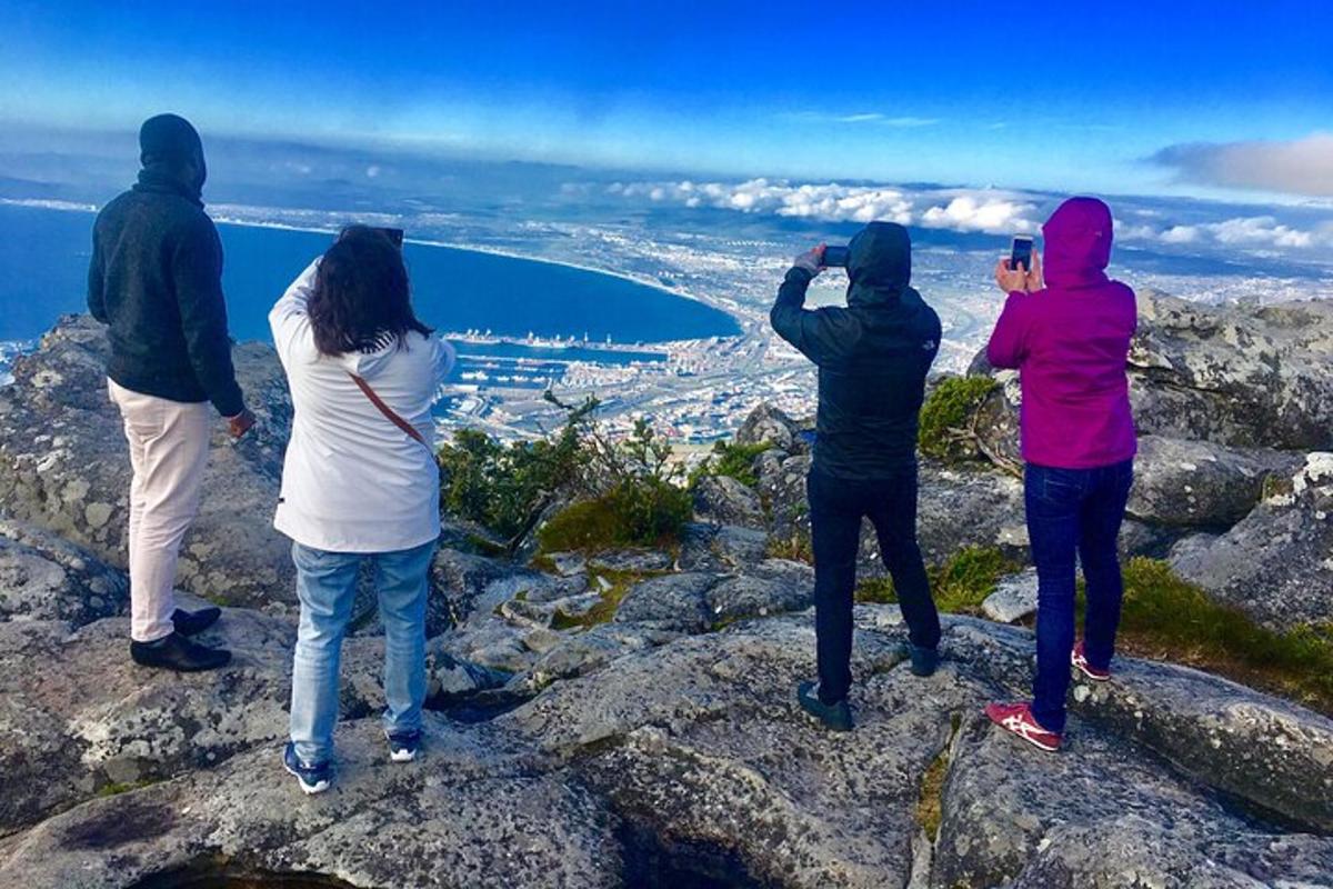 a group of people standing on top of a mountain