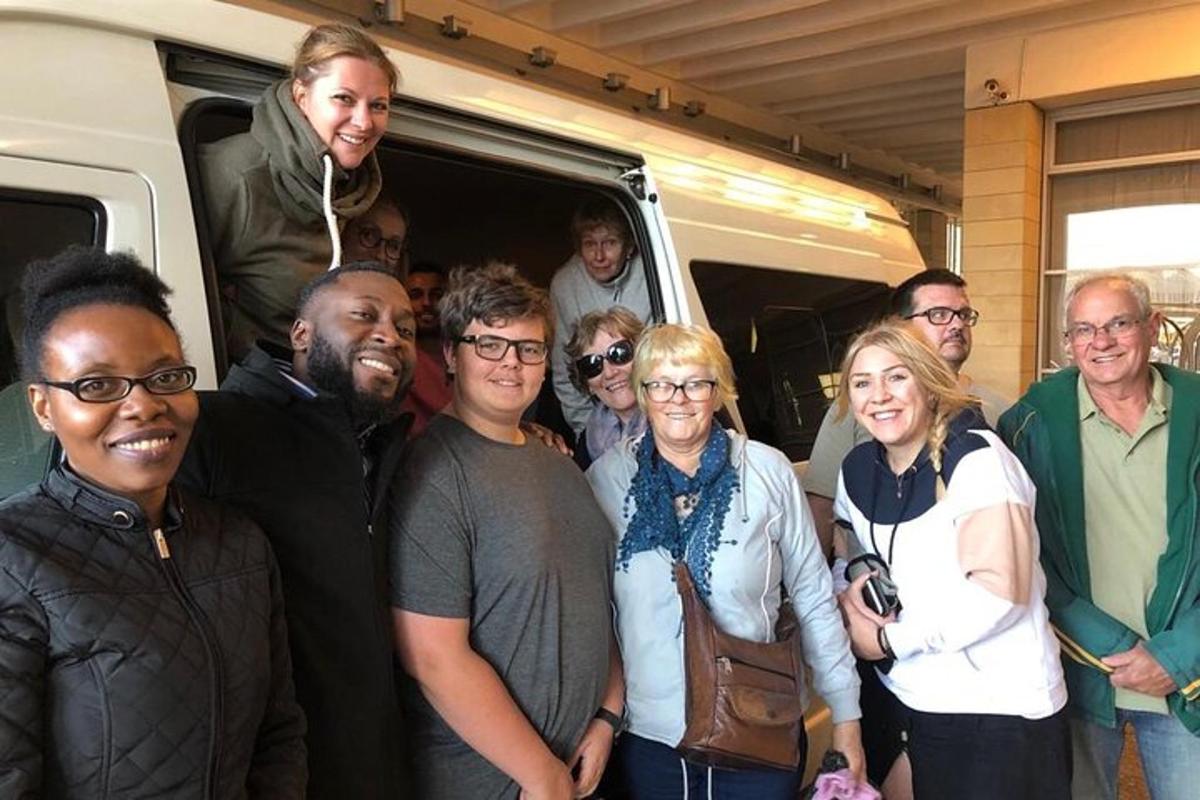a group of people standing in front of a van
