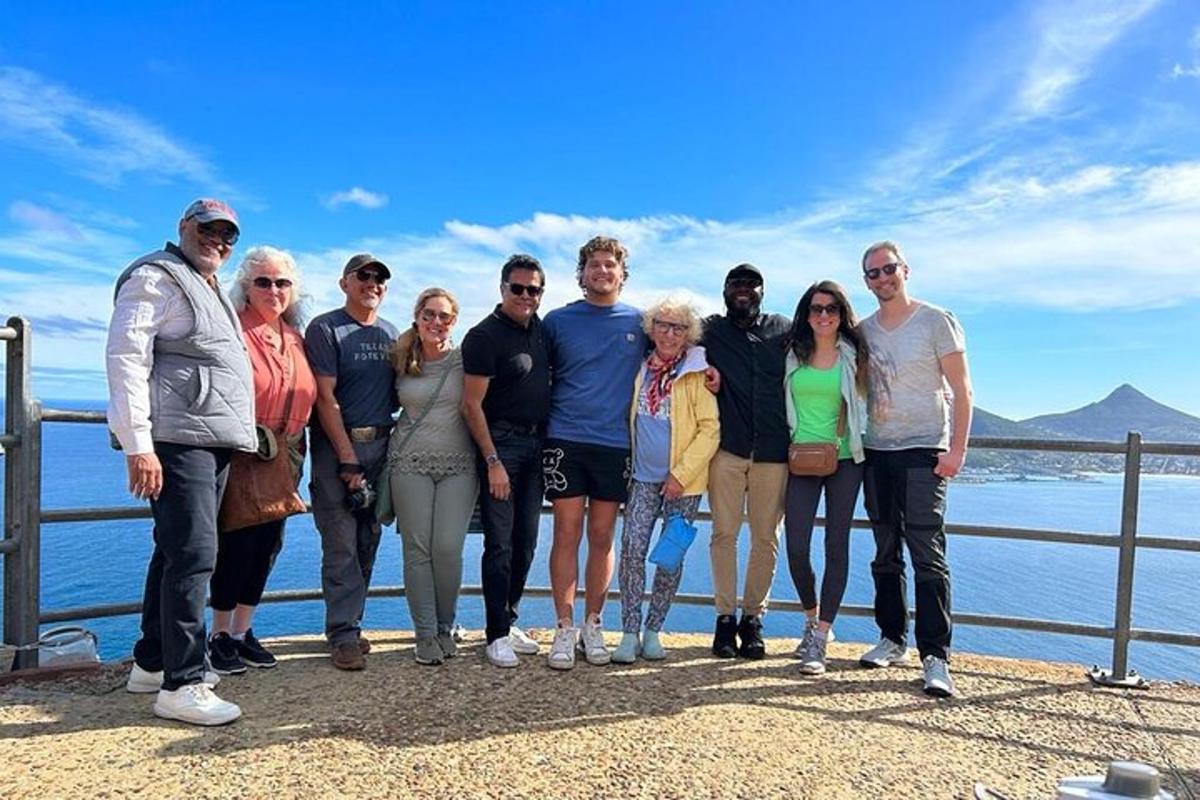 a group of people posing for a picture near the water