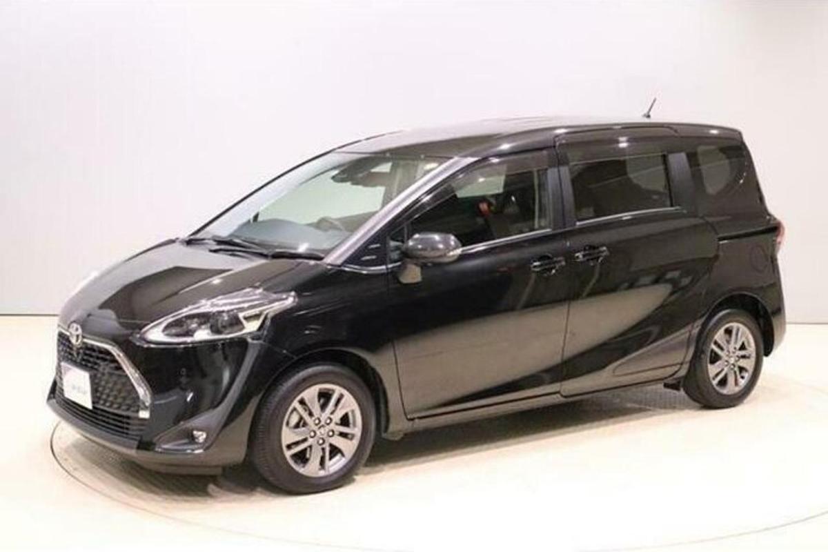 sebuah kereta hitam kecil sedang duduk di atas permukaan putih
