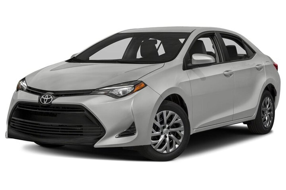 a white toyota corollaolla hybrid parked