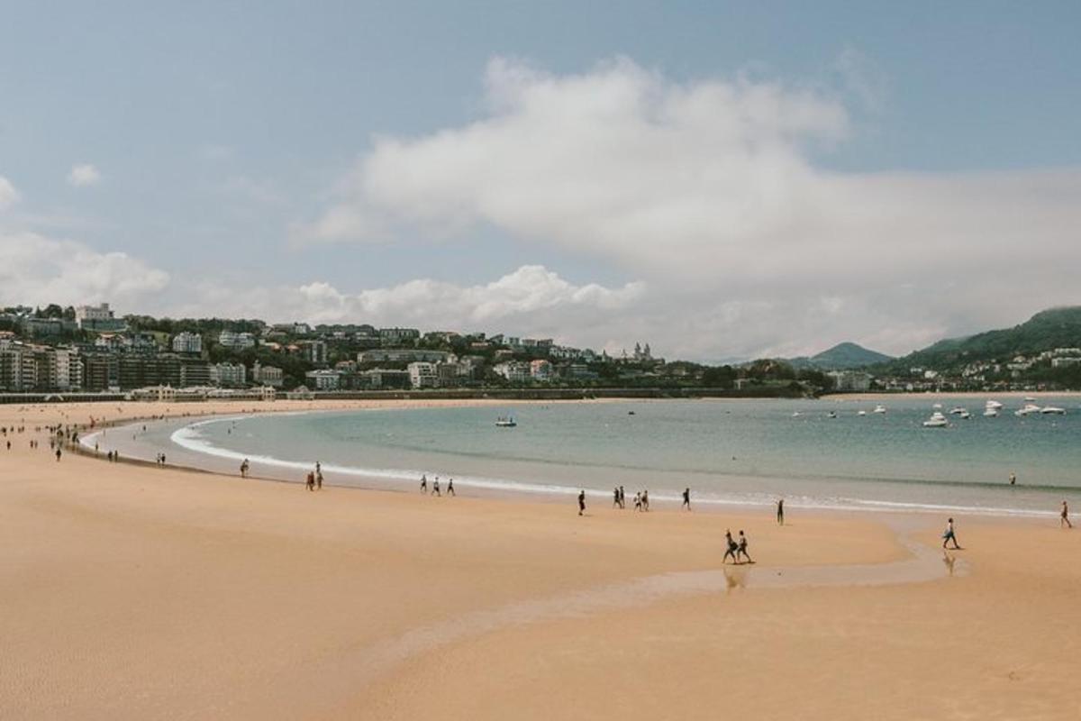 a group of people walking on a beach