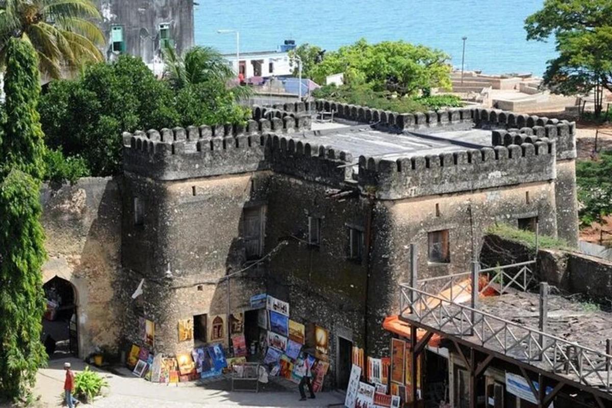 an old building with a market in front of the ocean