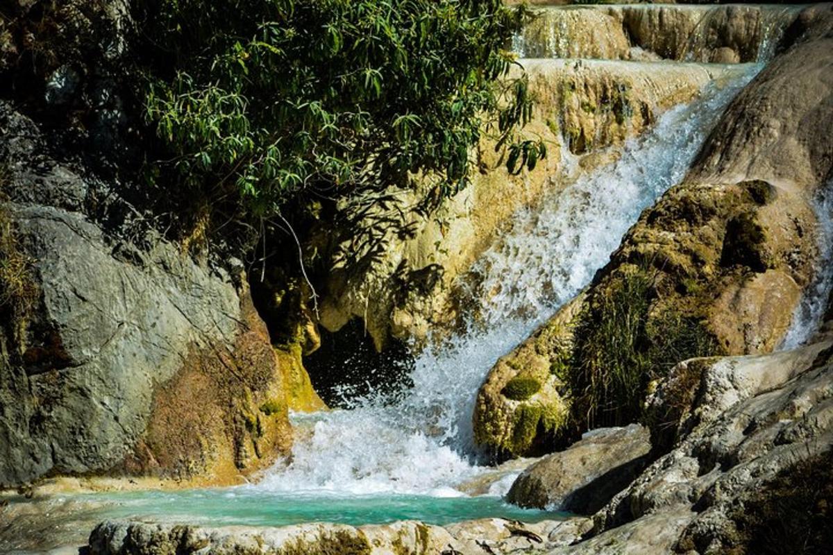 a waterfall on the side of a rocky cliff