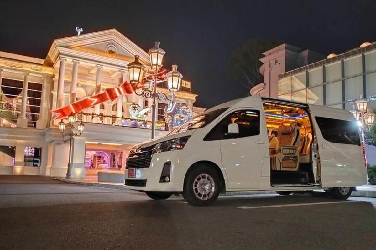a white van parked in front of a building at night