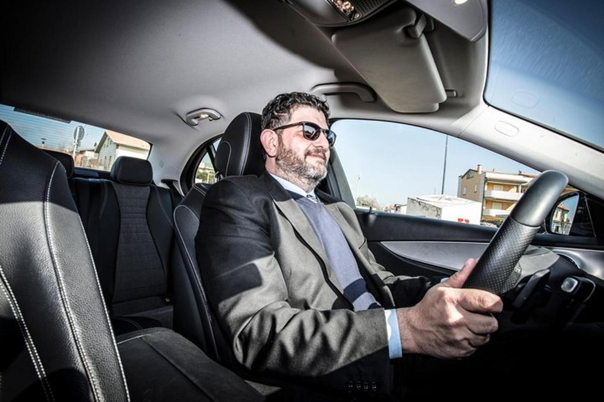 a man in a suit sitting in a car