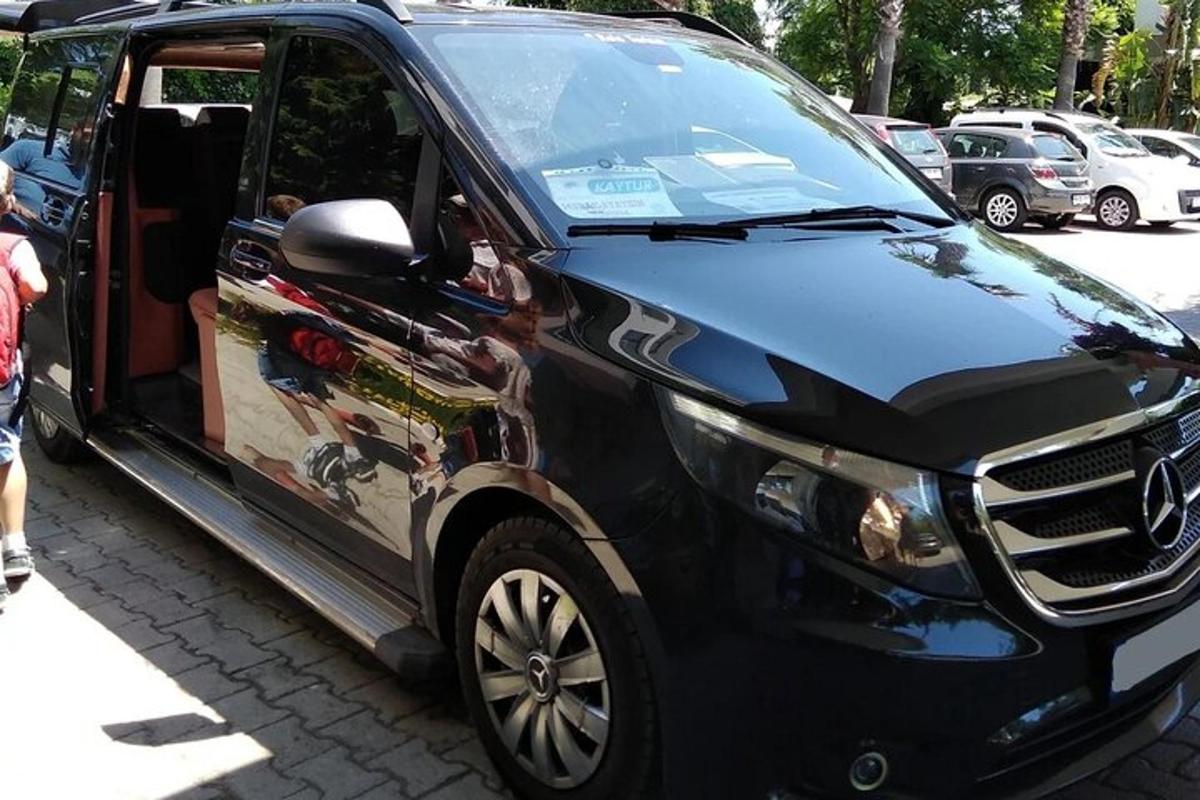 a black car with an open door on a street