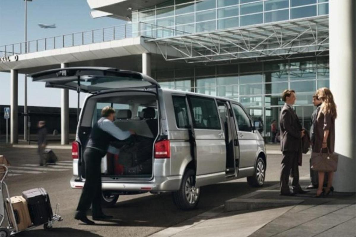 a group of people standing around a van with its door open