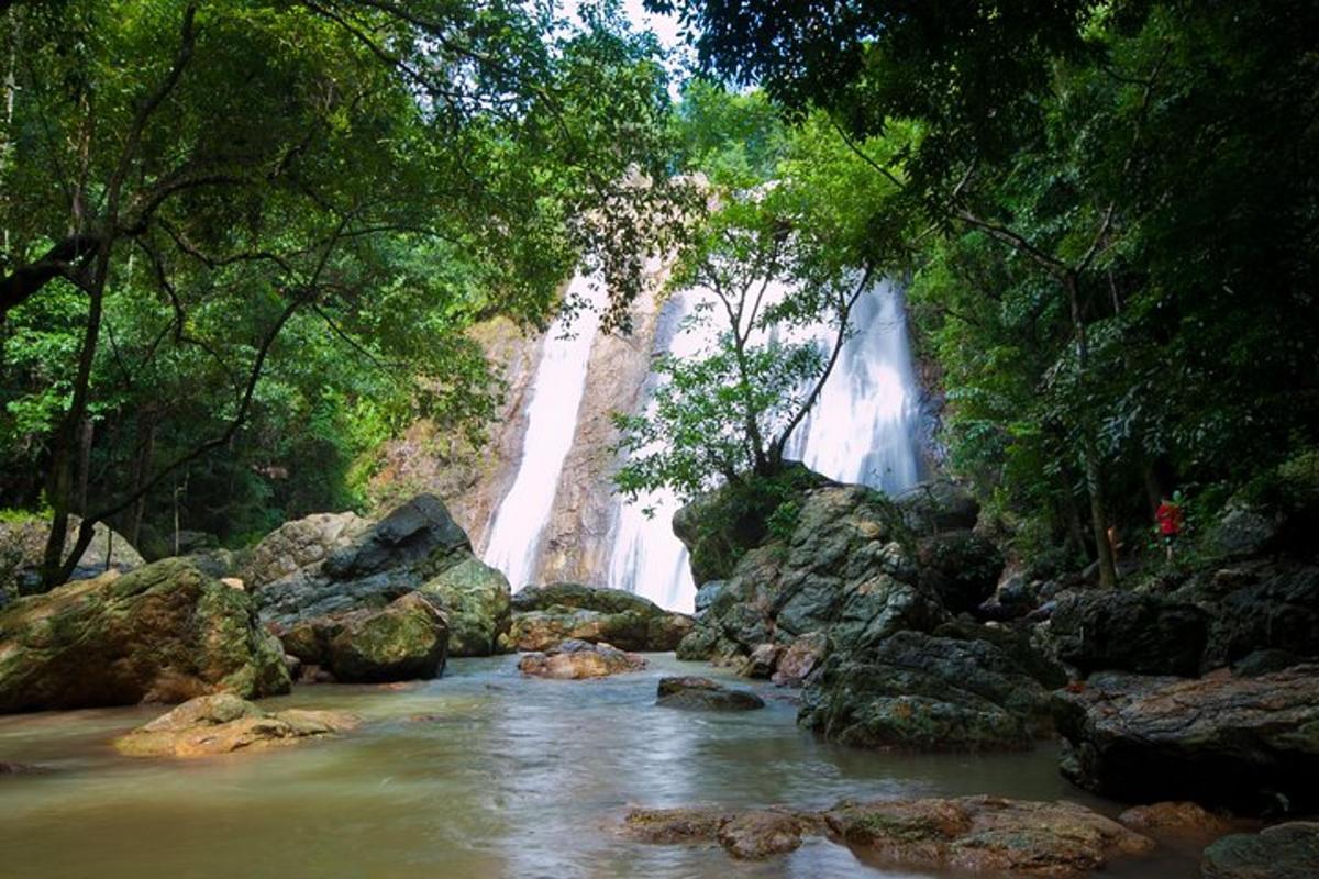 a waterfall in the middle of a river with rocks