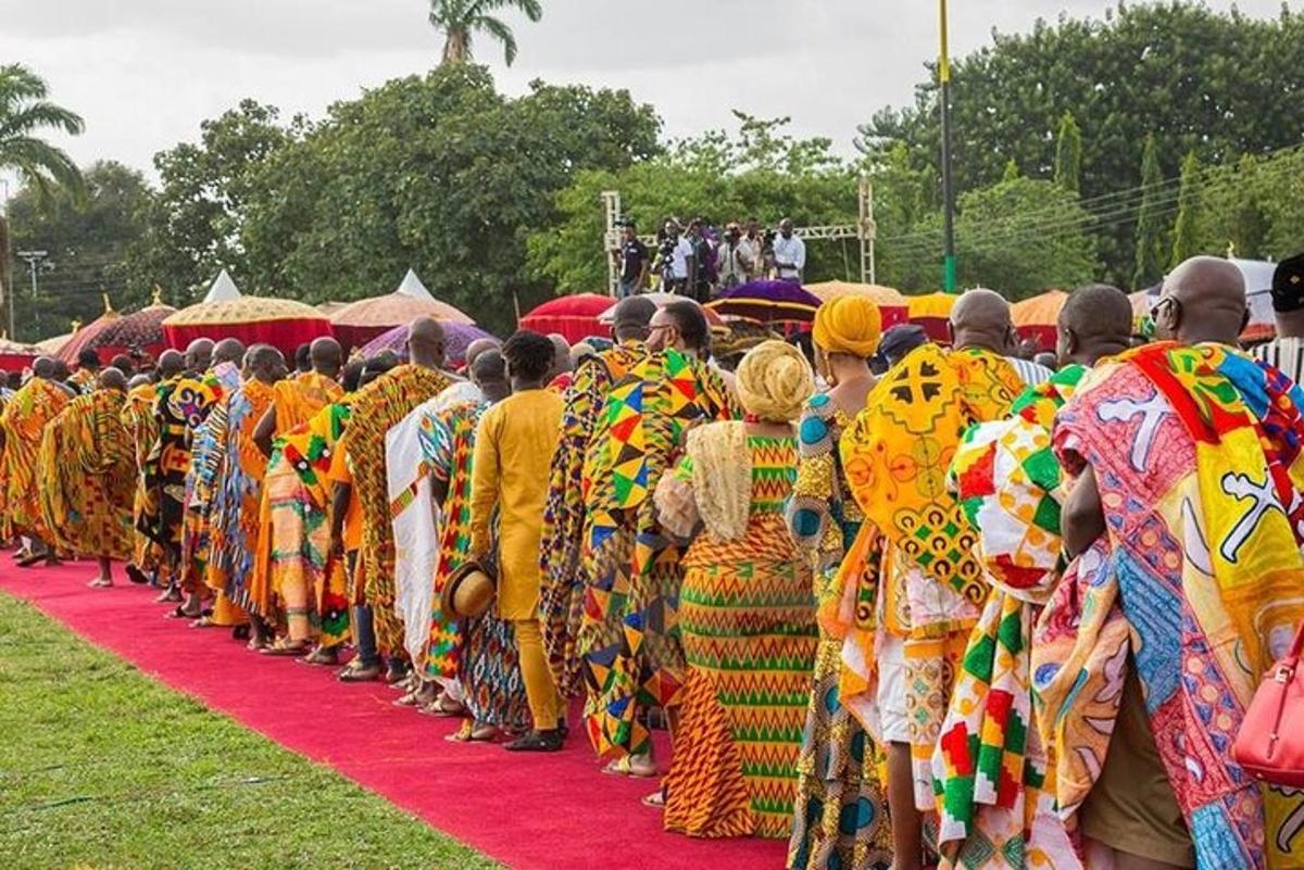 a group of people dressed in colorful clothing on a red carpet