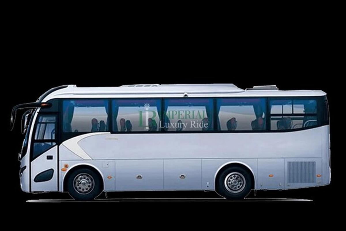 a white bus is parked in a parking lot