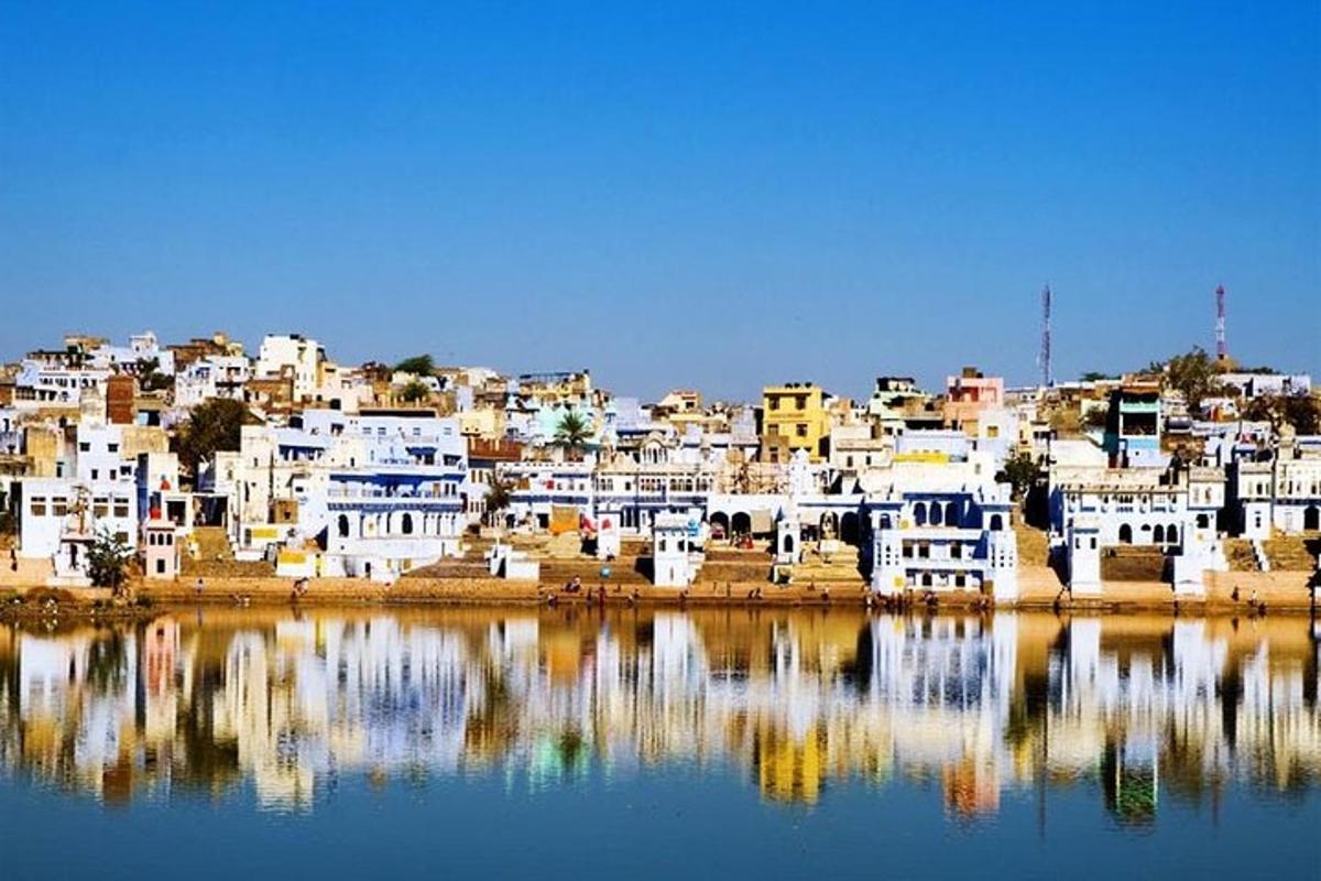 a group of white buildings sitting on top of a body of water