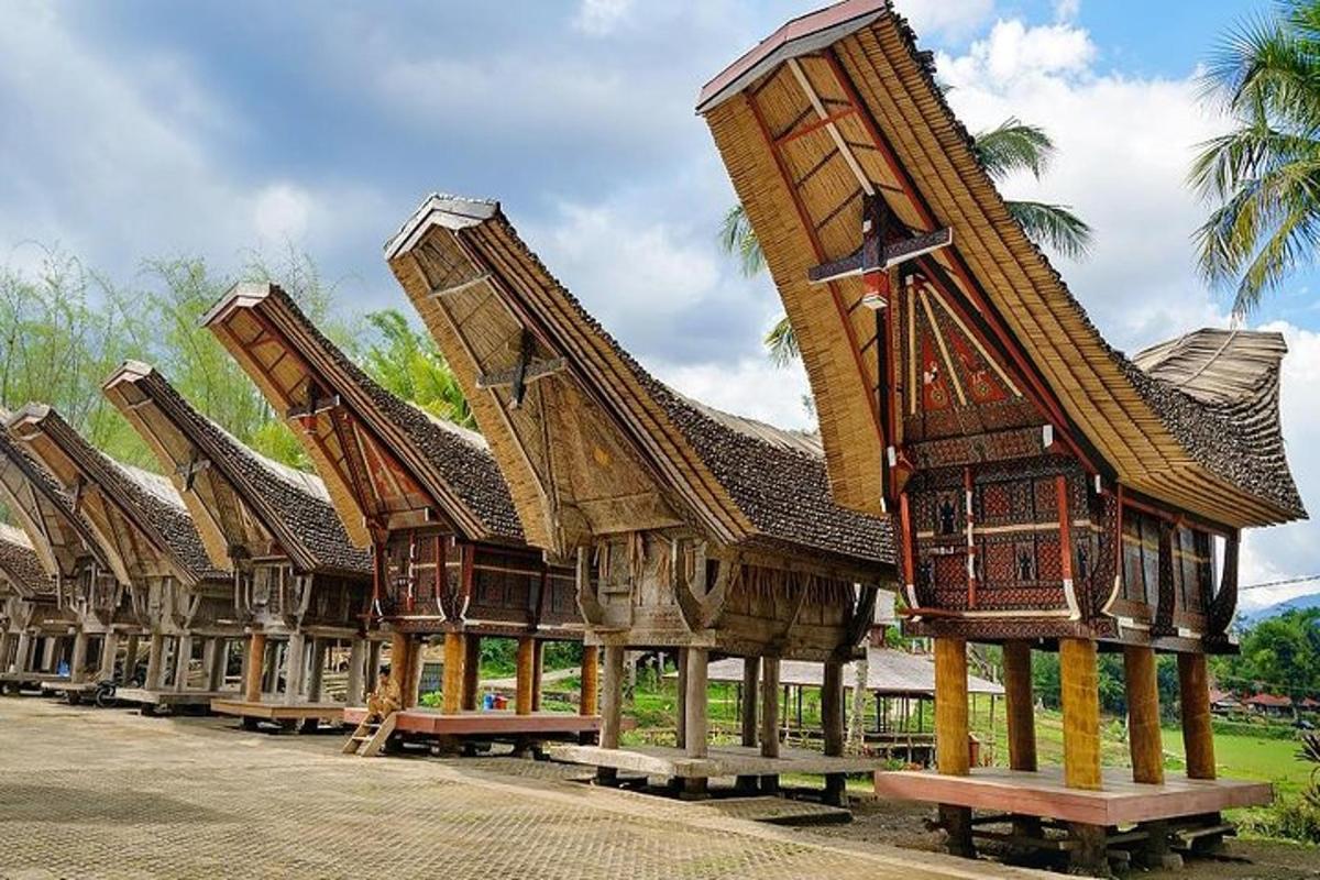 a row of buildings with roofs and benches