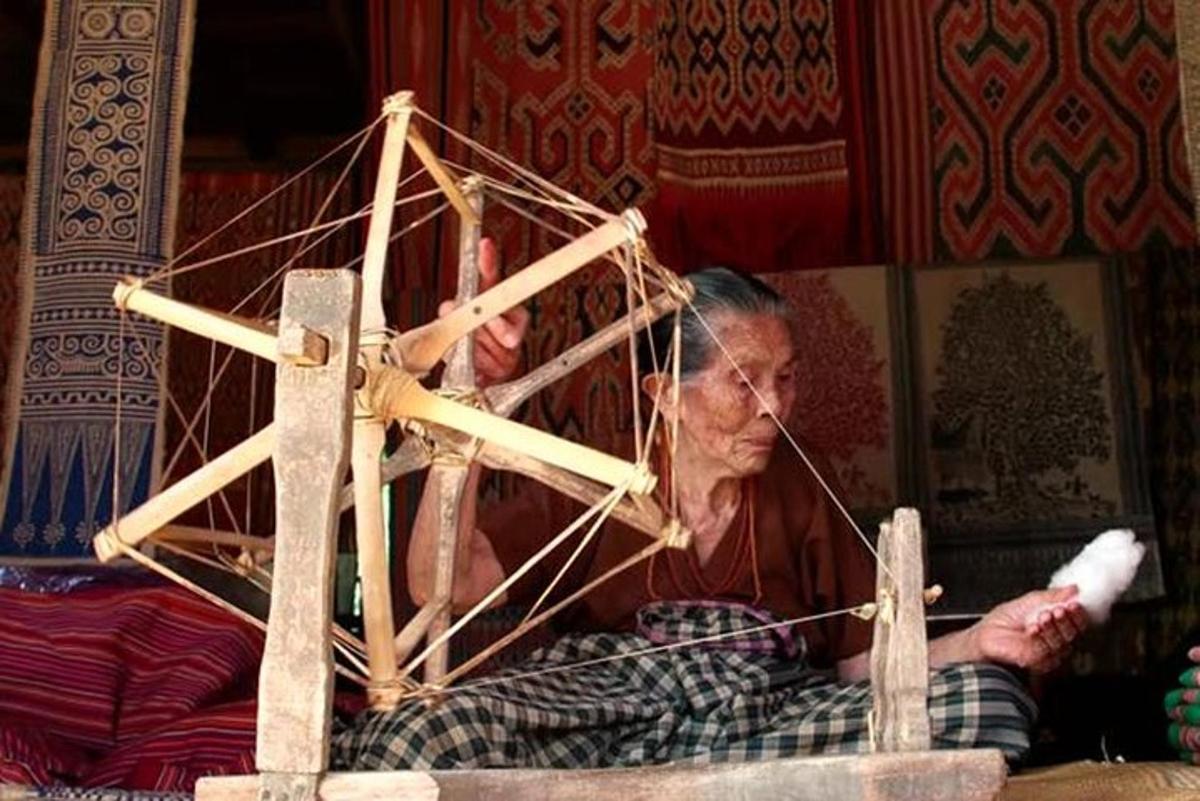 an older man is constructing a wooden structure