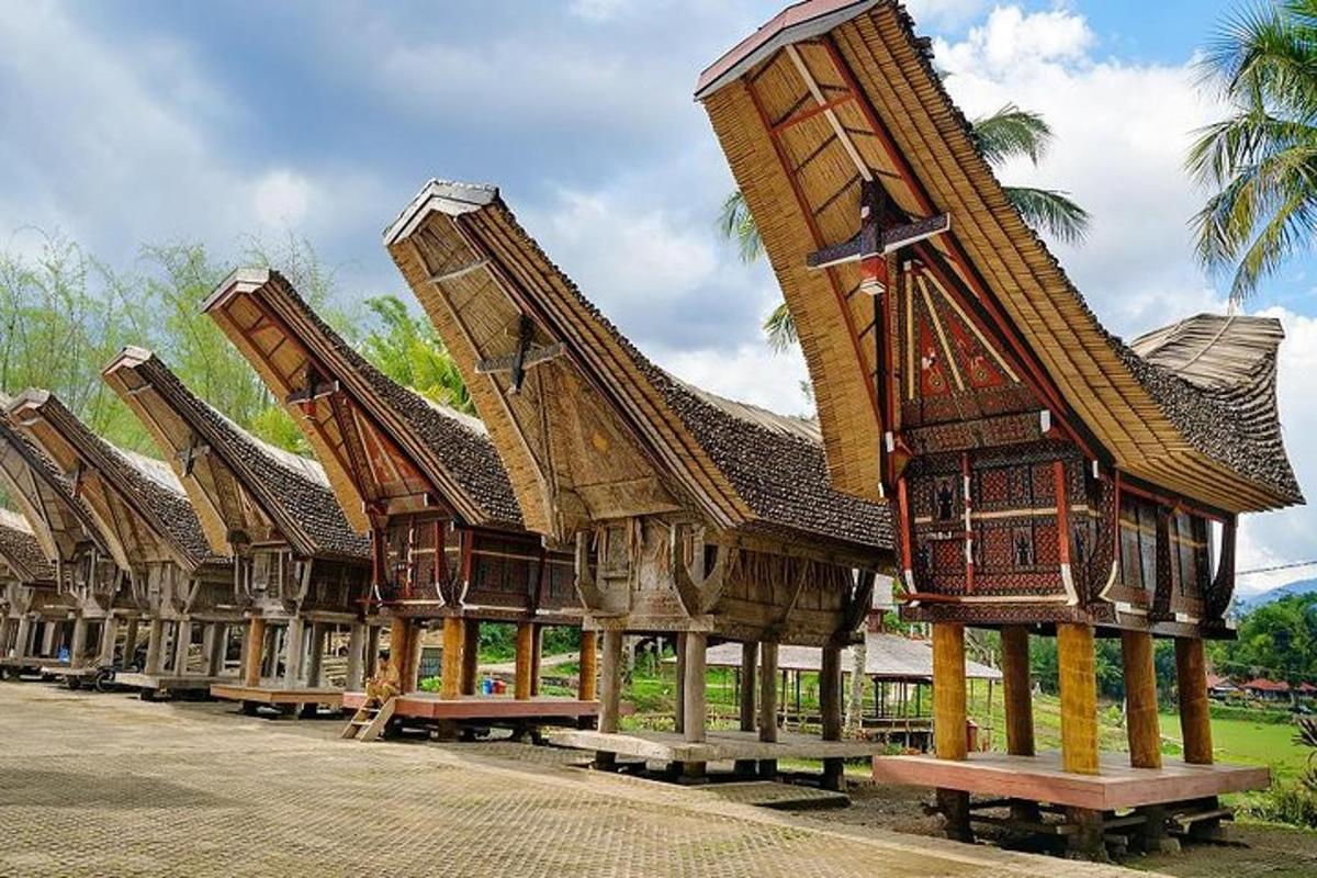 a row of buildings with roofs and benches