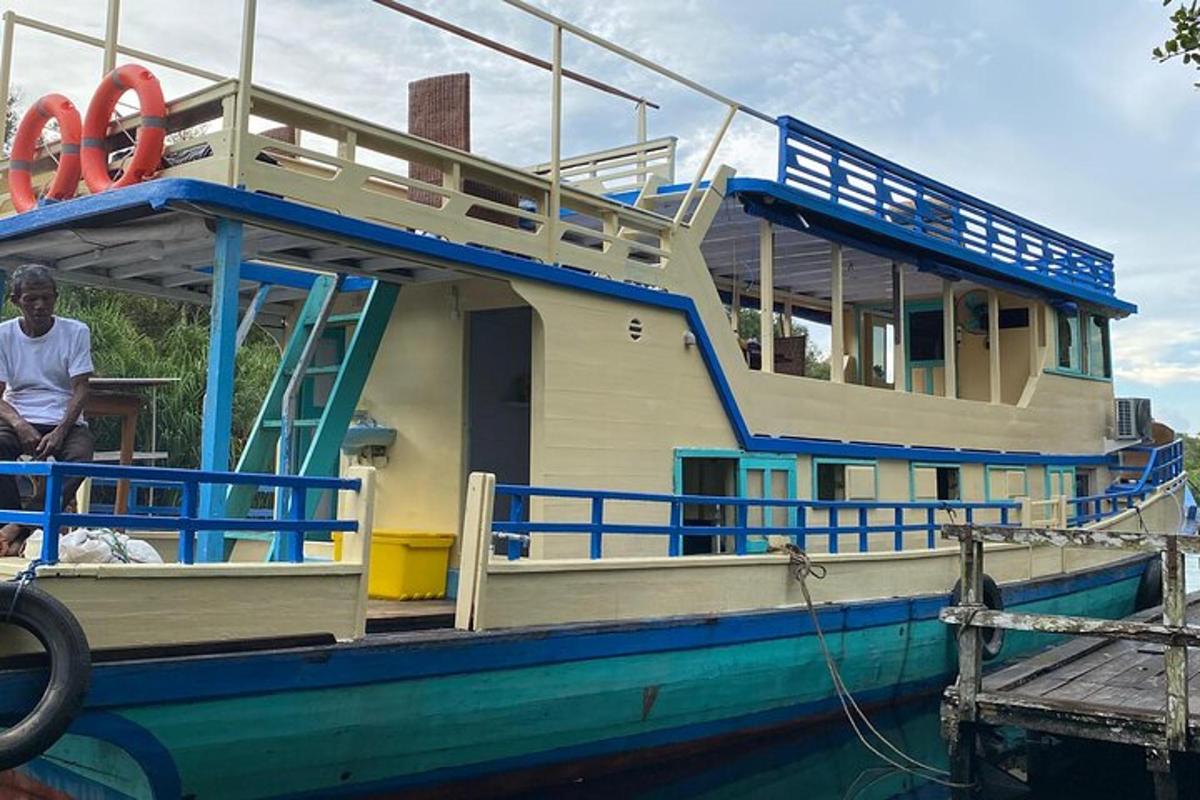 a man sitting on a boat in the water