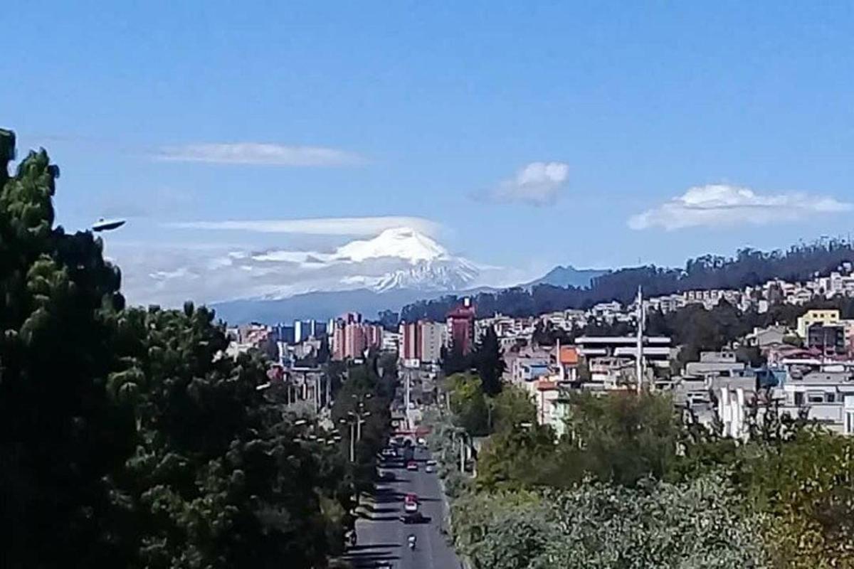 a view of a city with a snow covered mountain