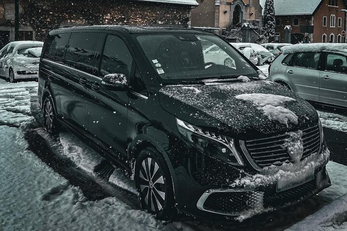 a black suv parked in a snow covered parking lot