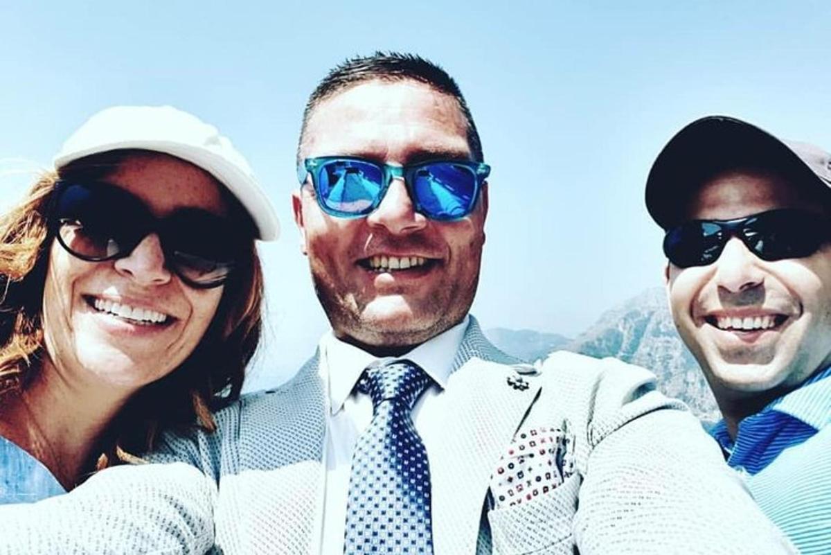 a group of three people wearing sunglasses and smiles