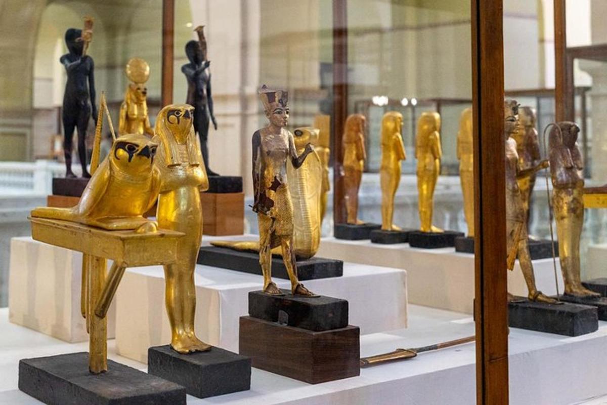 a group of gold statues on display in a museum