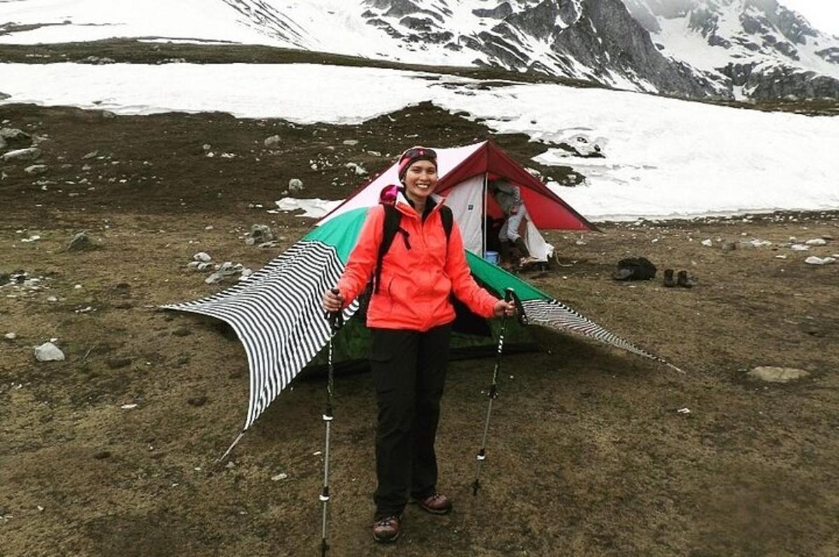 a man holding a umbrella in front of a tent