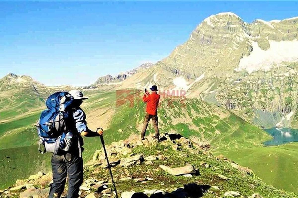 two people standing on top of a mountain