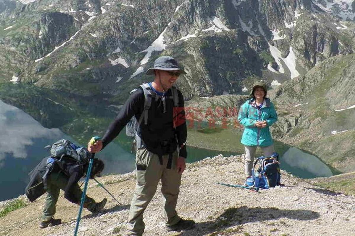 a man and a woman standing on top of a mountain
