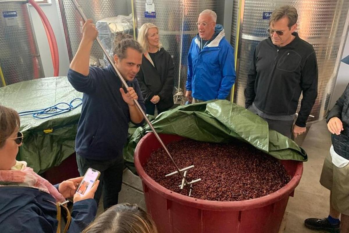 a group of people standing around a large pot of coffee