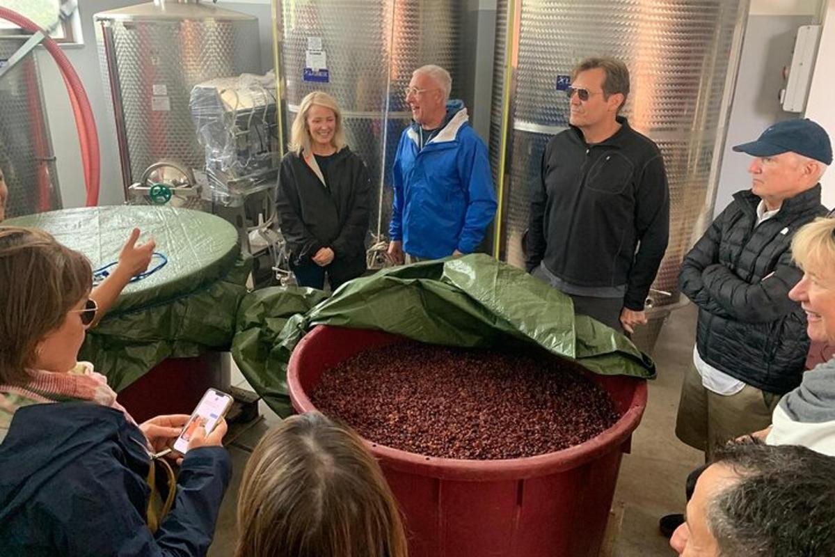 a group of people standing around a large pot of coffee