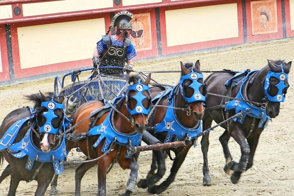 a man riding on a carriage being pulled by horses