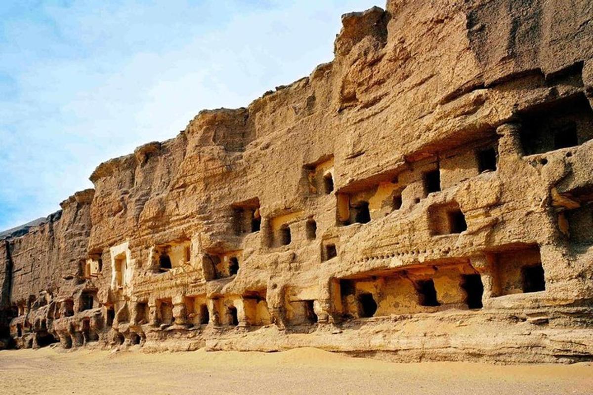 a rock wall with many windows on it