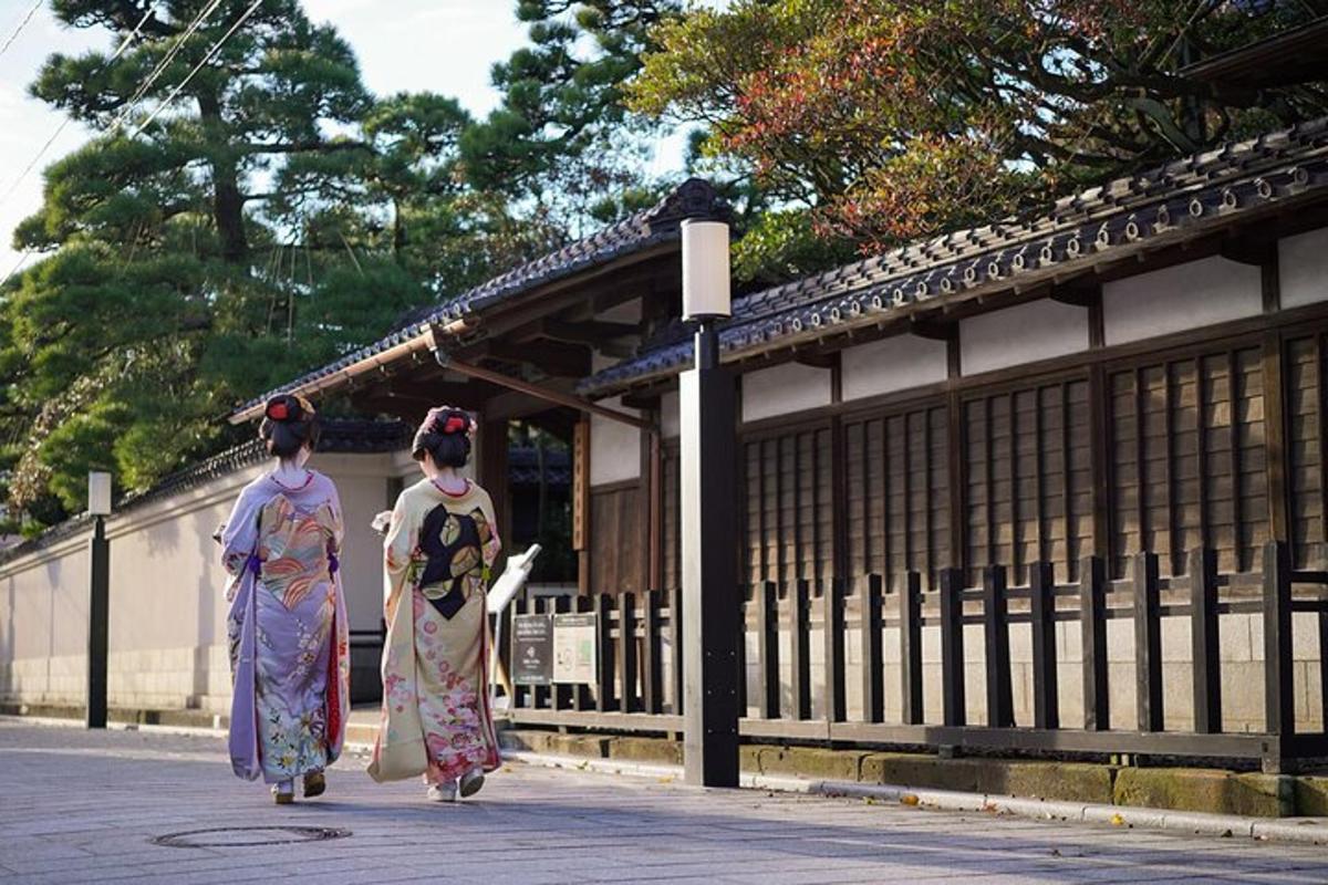 two women in kimonos walking down a street