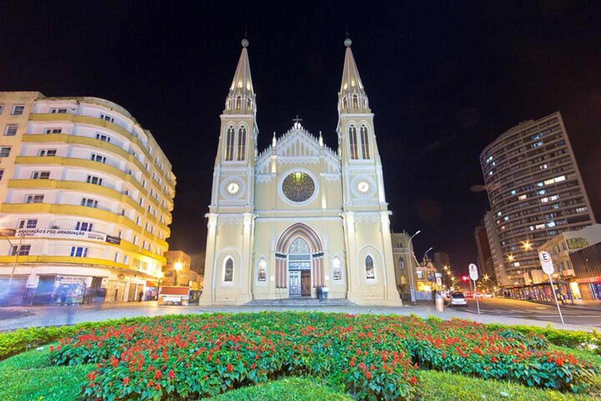 a white church with a clock tower at night