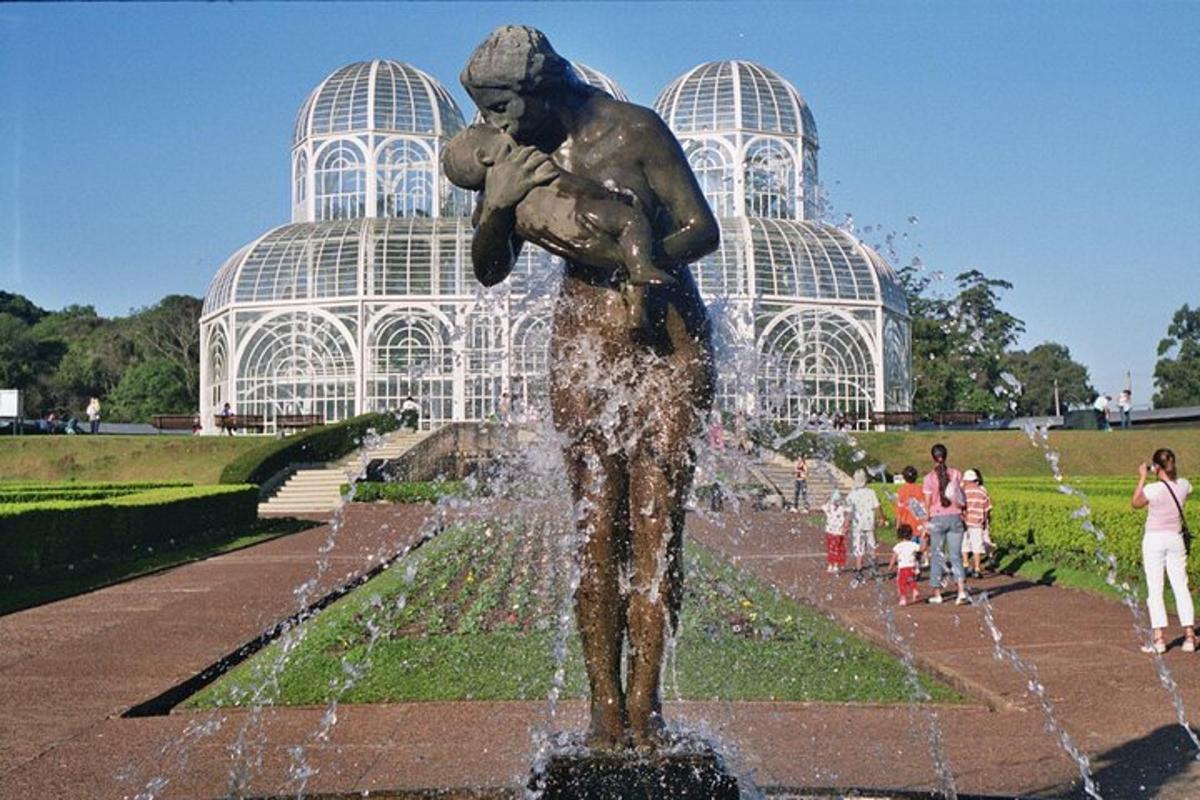 a statue of a woman holding a child in a fountain