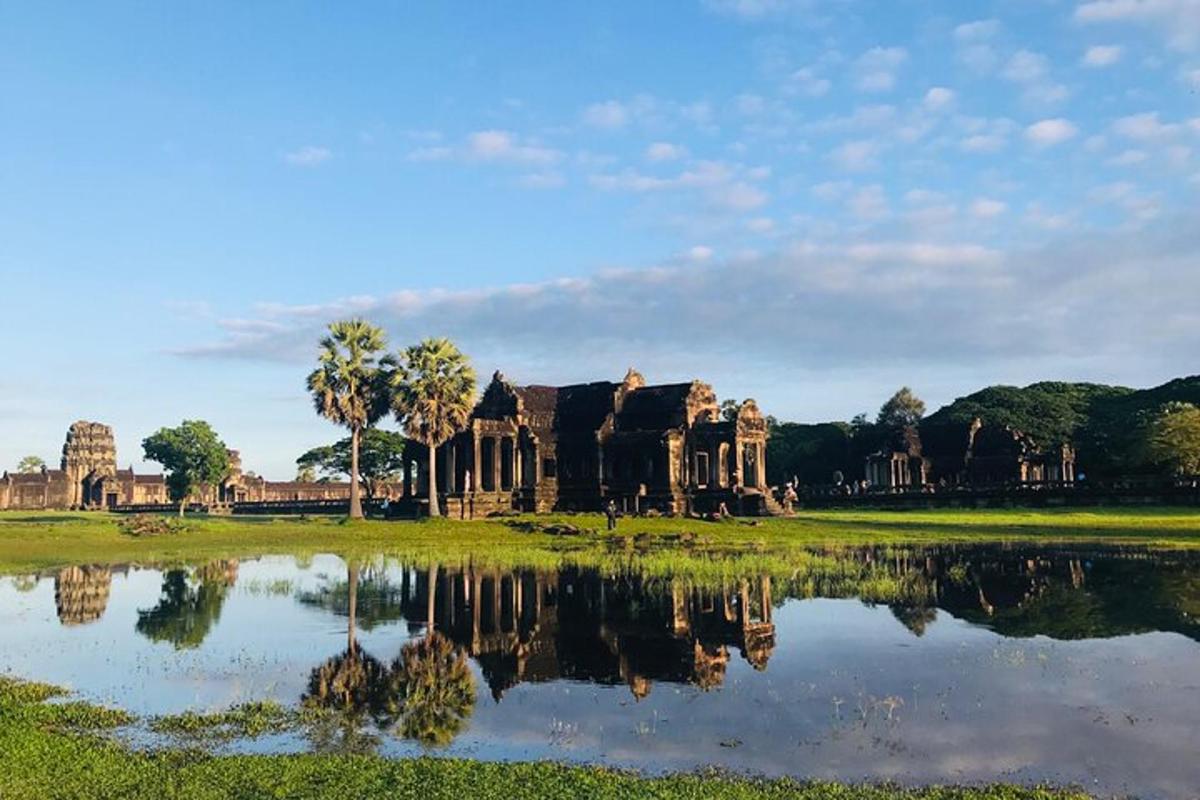 a view of the ruins of a building next to a lake