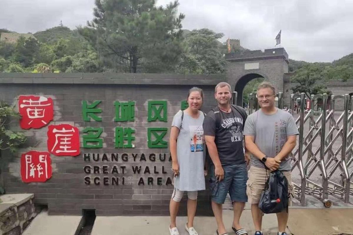 a group of three people standing in front of a gate