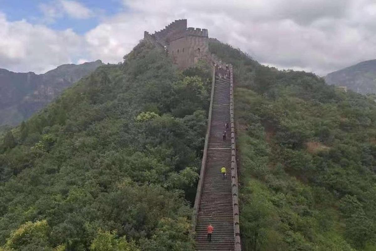 a person is standing on a train track on a mountain