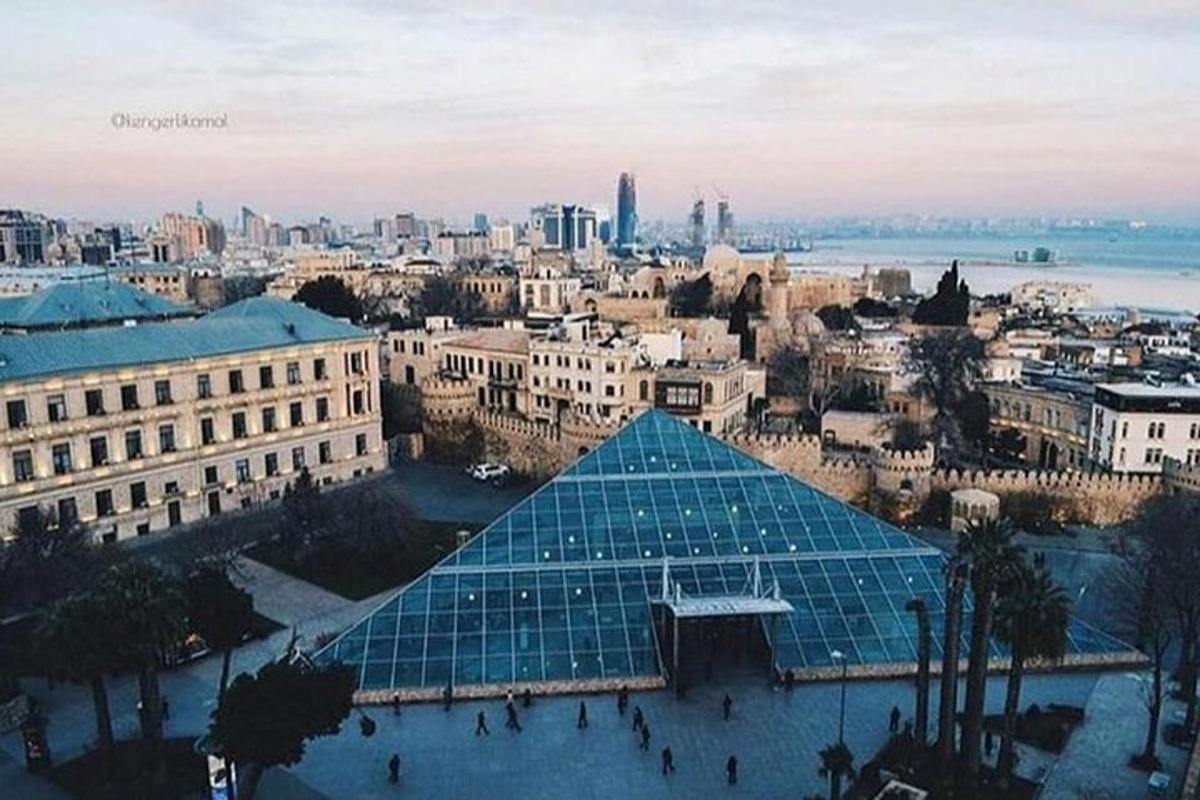 a view of a city with a glass pyramid