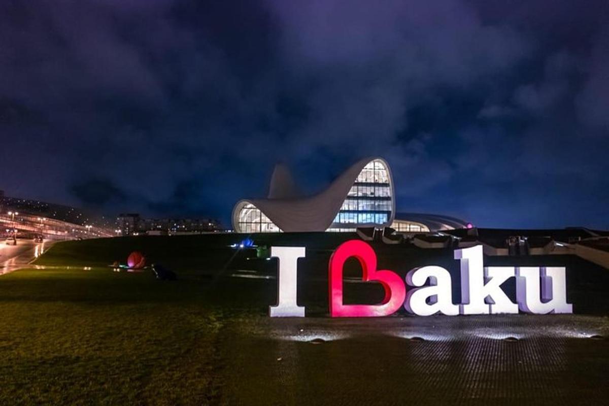a sign in front of a stadium at night